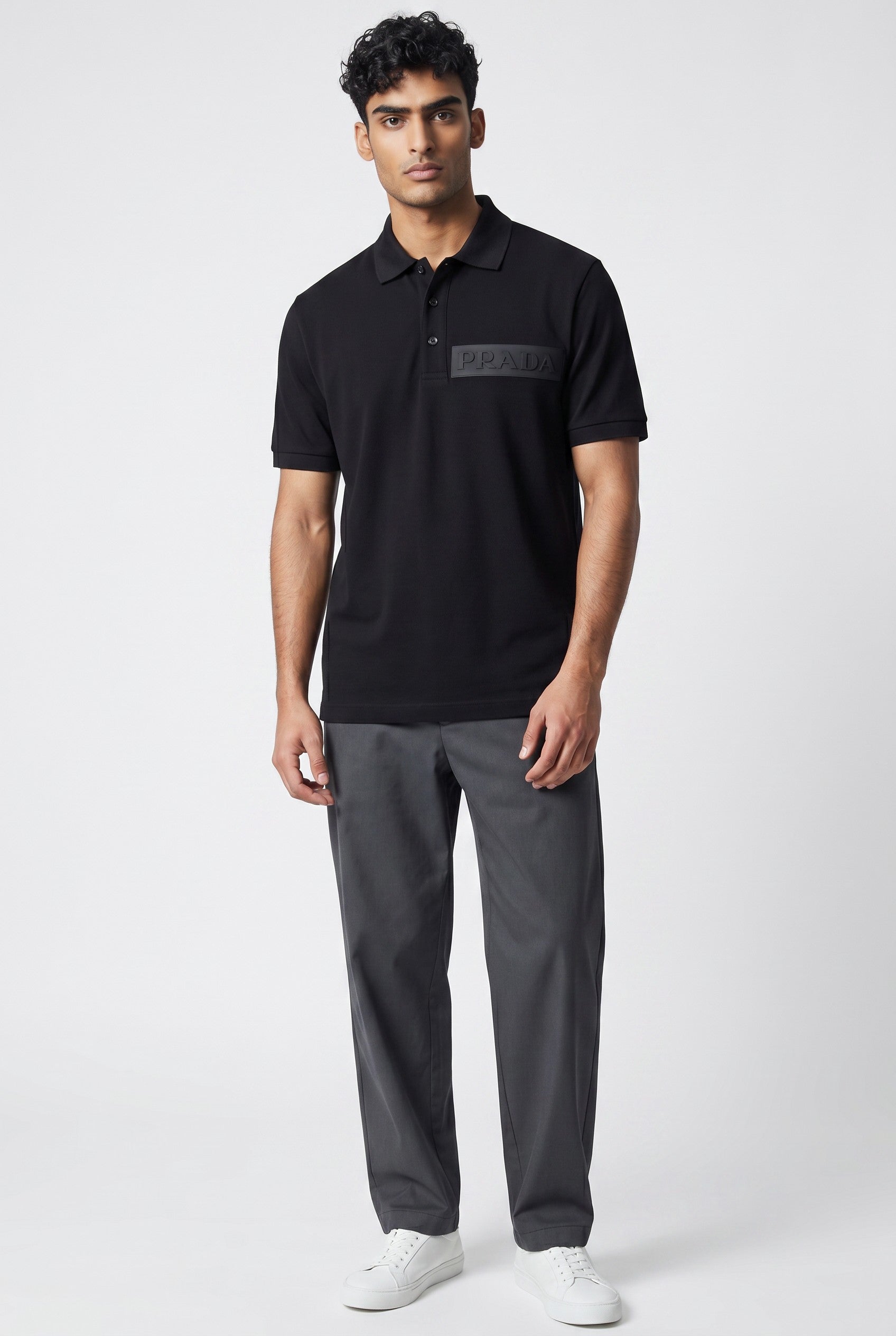 MASTERPIECE black stretch fabric polo shirt with tonal embossed Prada logo on chest and classic collar.