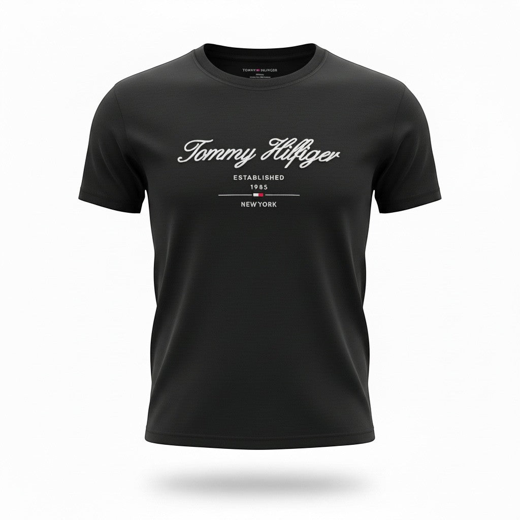 MASTERPIECE black cotton t-shirt with white Tommy Hilfiger script logo and established 1985 New York detail. Crew neck, short sleeves.