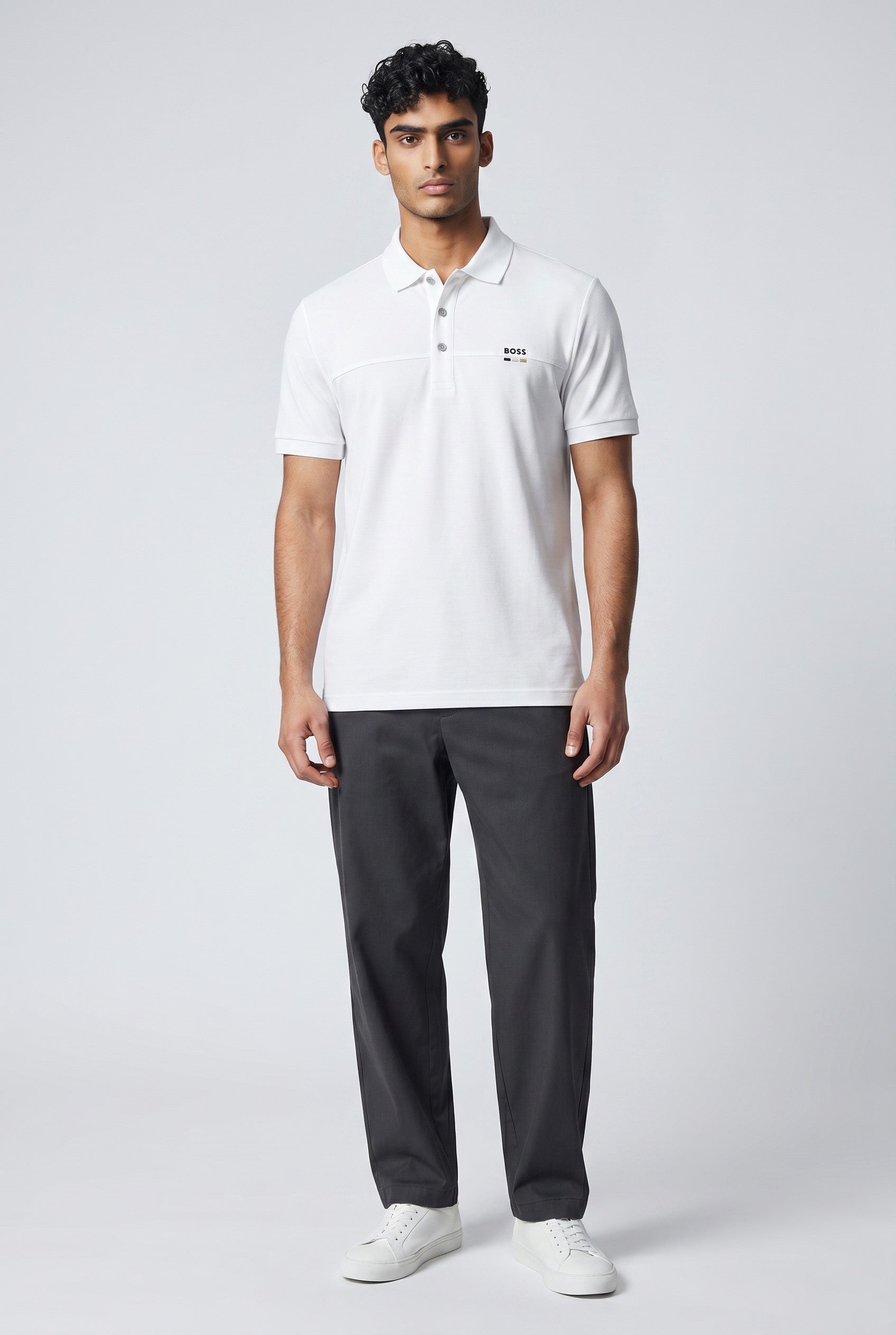 MASTERPIECE BOSS white textured polo shirt with subtle perforated logo detail and minimal chest logo accent.