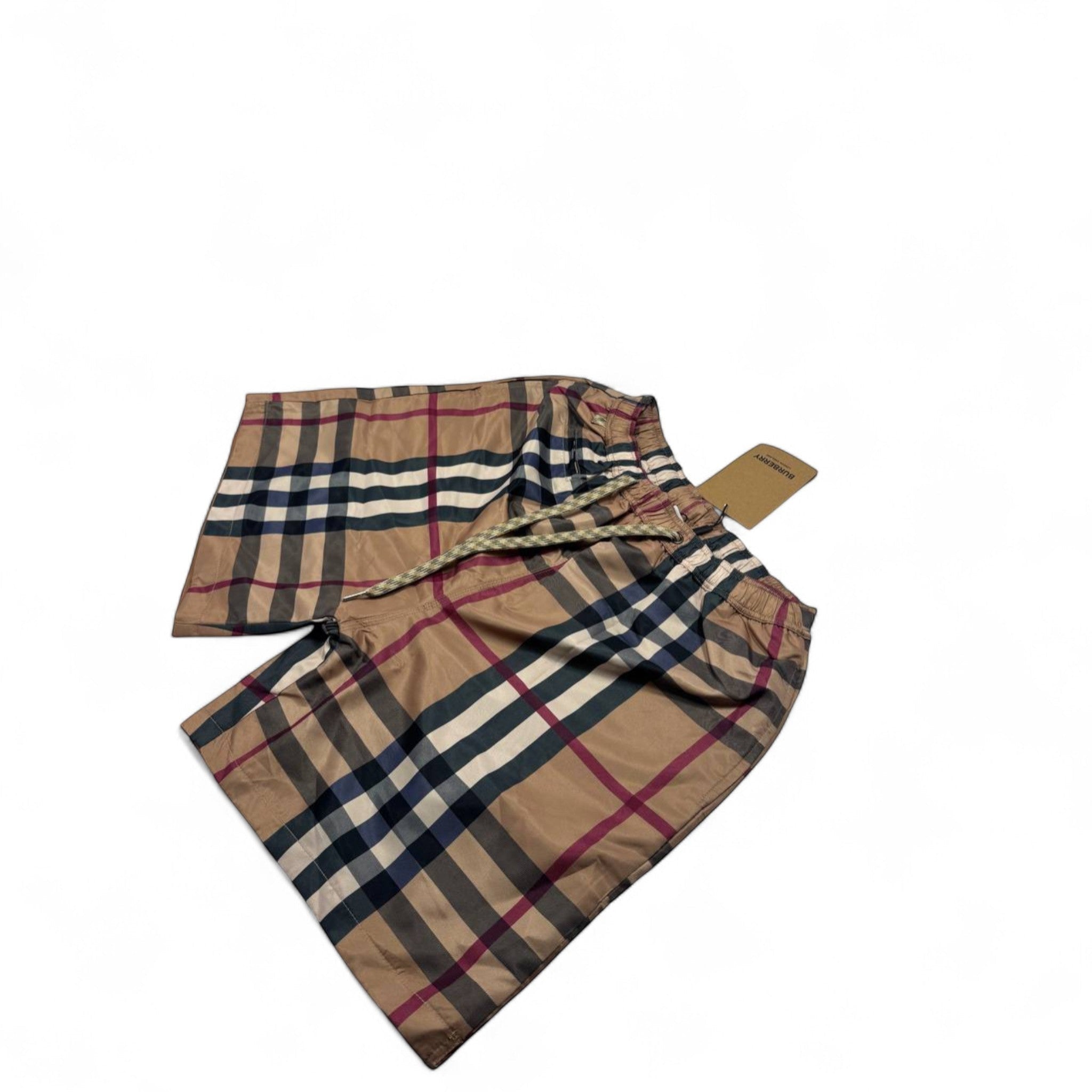 MASTERPIECE beige swim shorts with iconic Burberry check pattern and drawstring waist.