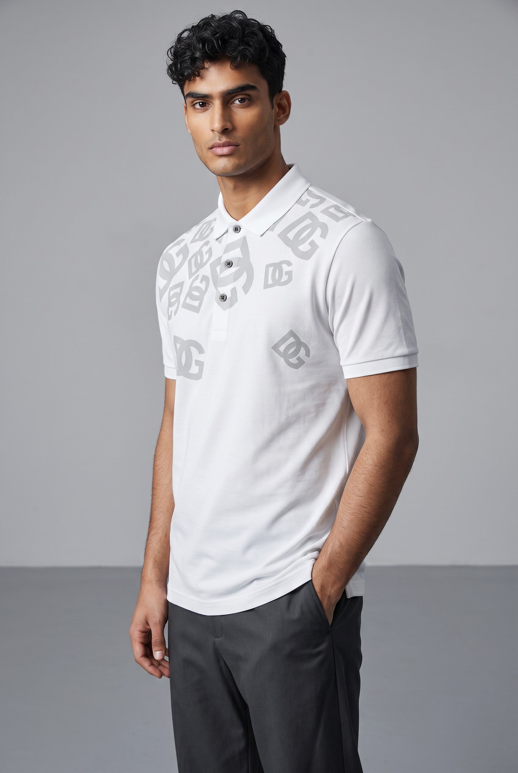 MASTERPIECE presents a white Dolce & Gabbana polo shirt with an all-over subtle DG monogram print and black buttons.