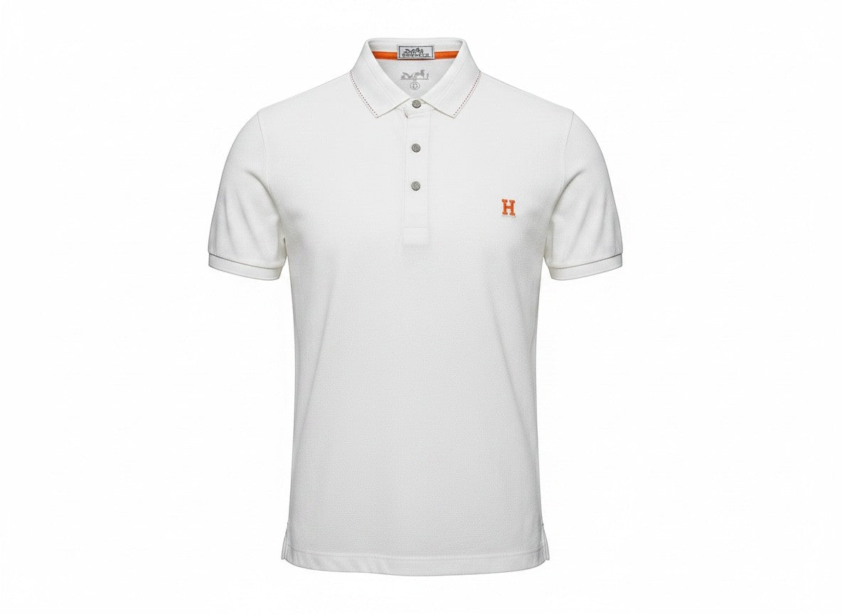 MASTERPIECE Hermès white textured polo shirt with orange embroidered H logo and contrast stitching on collar and cuffs.