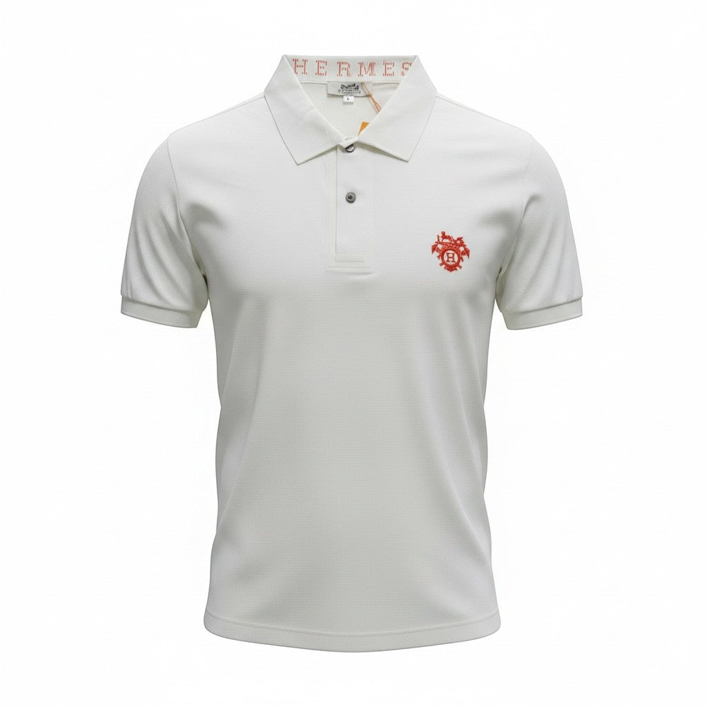 MASTERPIECE white polo shirt with red crest logo on chest, classic collar, and signature Hermรจs detail inside collar.