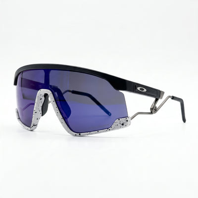 Oakley shield sunglasses with purple one-piece lens, black top frame and speckled white lower trim