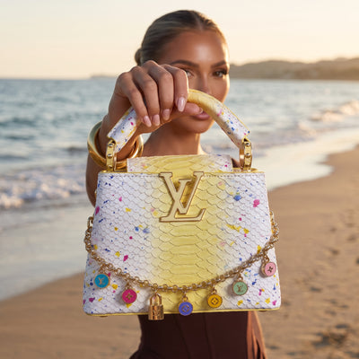 Yellow and white LV top-handle bag with colorful enamel charms and gold LV logo
