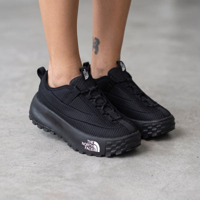 The North Face black trail sneaker with chunky lug sole and visible logo on midsole