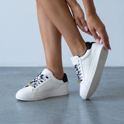 white Karl Lagerfeld low-top sneakers with black heel and KARL logo