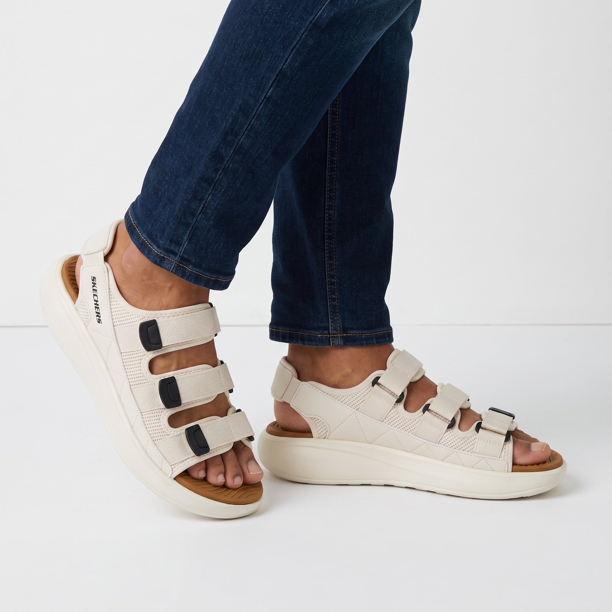 Cream Skechers platform sandal with three adjustable straps and tan footbed