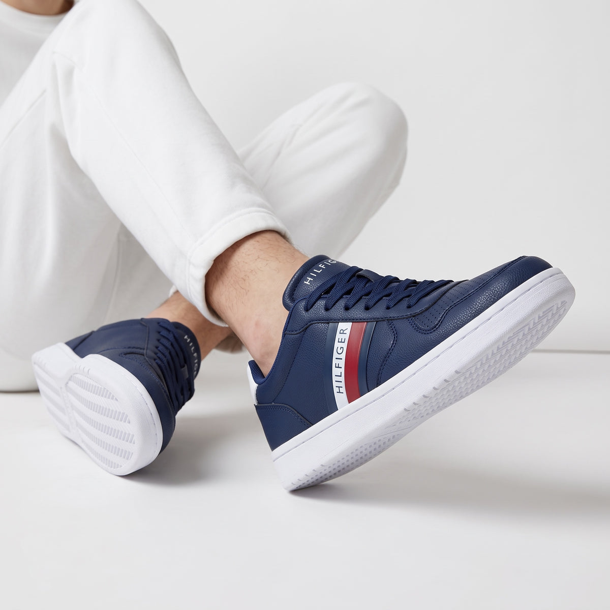 navy Tommy Hilfiger low-top sneaker with white sole and red stripe