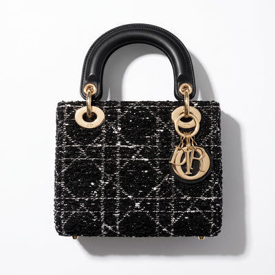 Dior Lady Dior mini top-handle bag in black tweed with gold hardware and Dior letter charms