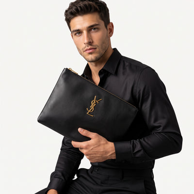 Saint Laurent black zip pouch with gold YSL logo held as a clutch