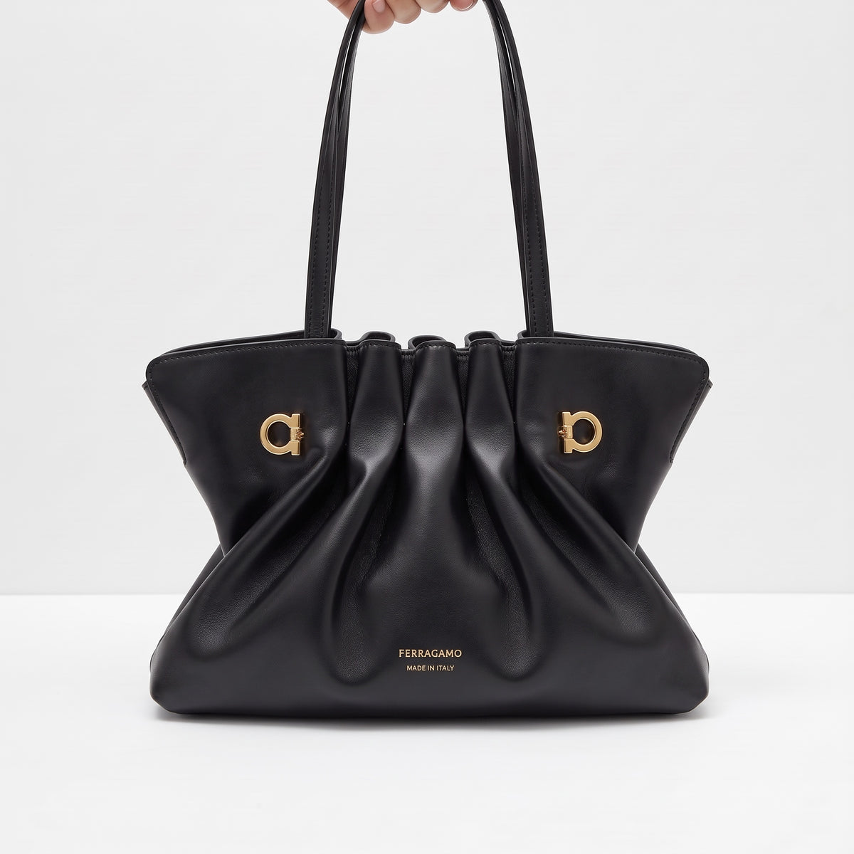 Black Ferragamo gathered tote with gold Gancini hardware and double top handles