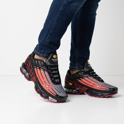 Nike Air Max Plus black and red gradient sneakers with visible Tuned Air units