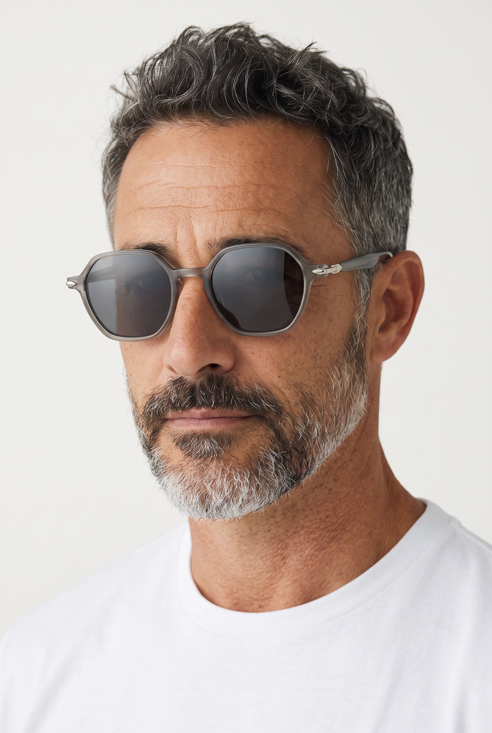 Men's translucent grey Persol sunglasses with dark lenses and silver arrow hinge