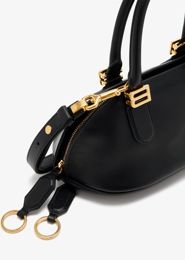Black Balenciaga dome satchel with gold B hardware and top handles