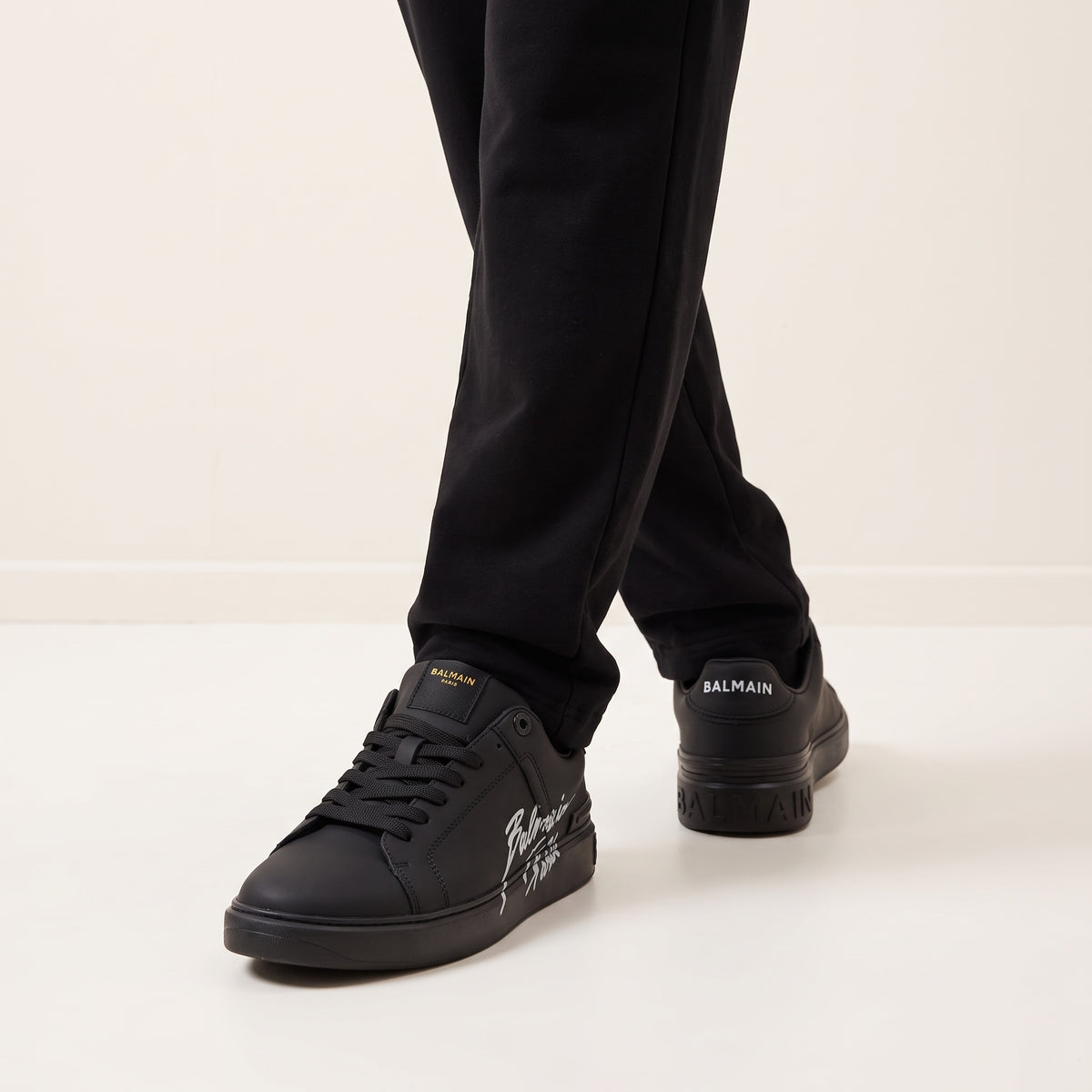 Black Balmain low-top sneakers with script logo on side and branded heel