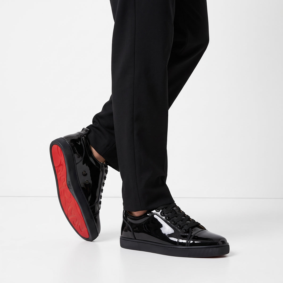 black patent low-top sneakers with red sole