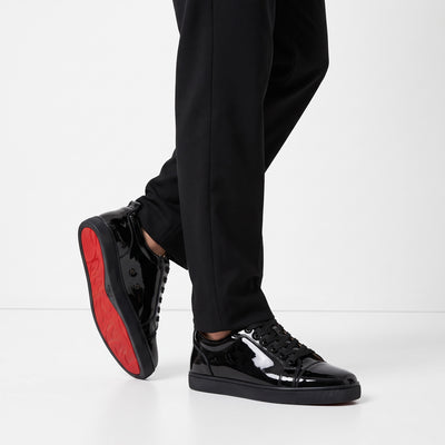 black patent low-top sneakers with red sole