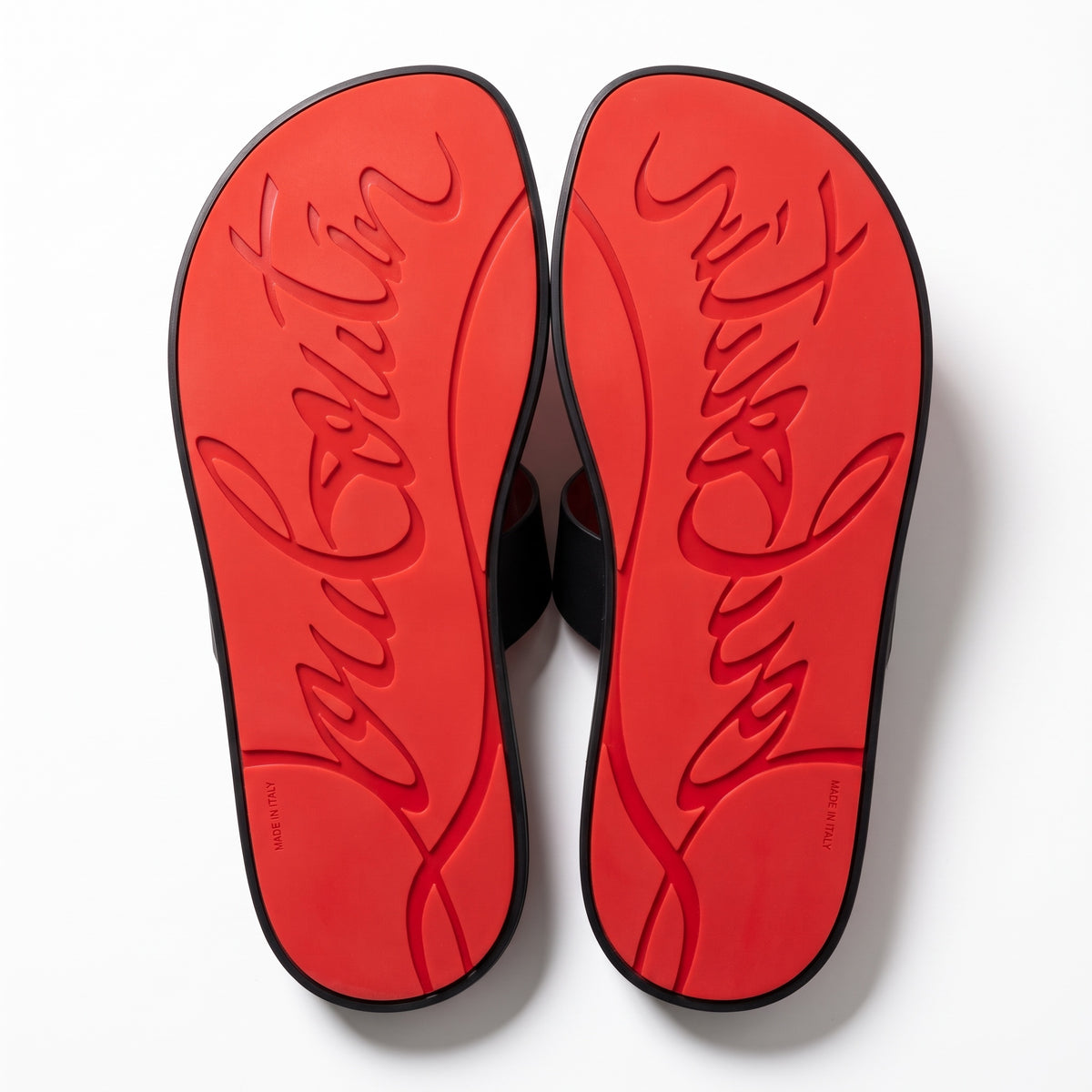black Christian Louboutin rubber slide with red sole and gold-tone bar