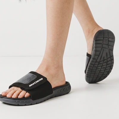 Black Skechers slide sandals with adjustable strap and Skechers logo