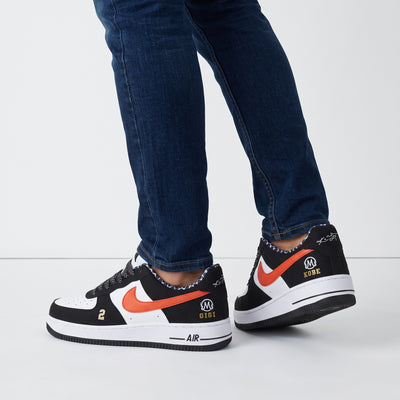 Nike Air Force 1 low-top sneakers in black white with orange Swoosh