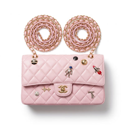 pink quilted Chanel flap bag with gold chain straps and charm pins