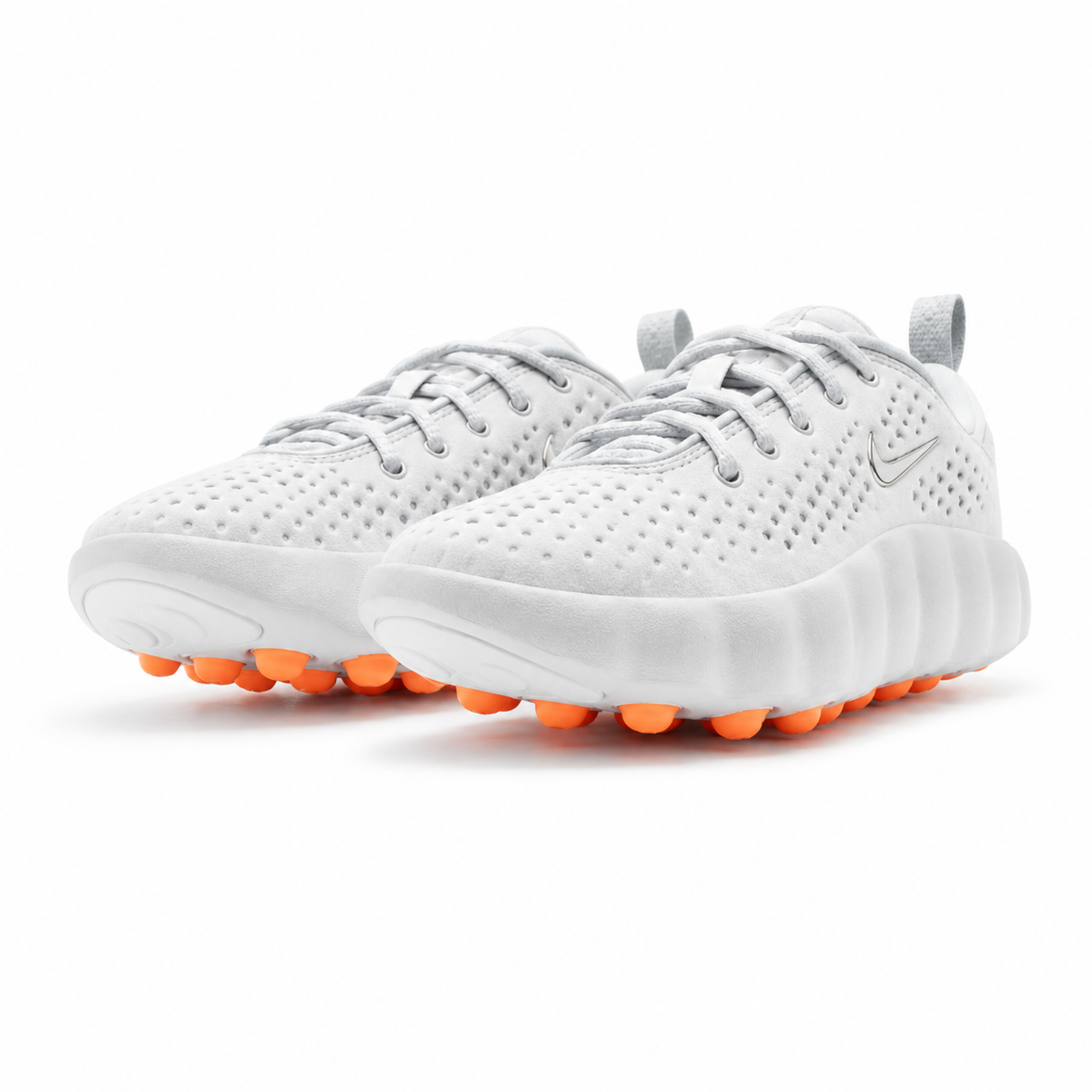 White Nike perforated sneakers with orange pod sole shown from multiple angles