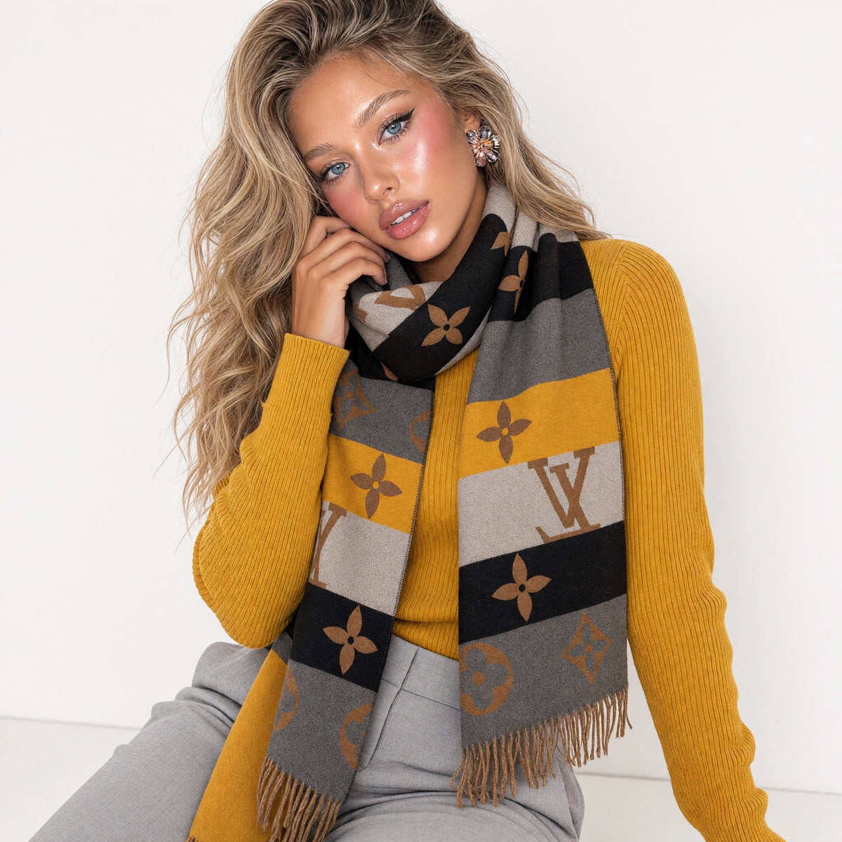 brown Louis Vuitton monogram scarf with fringe draped around model neck
