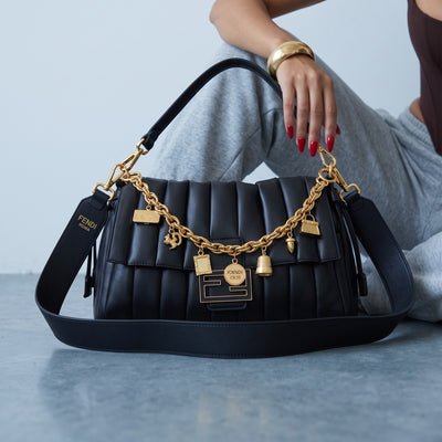 Black quilted Fendi shoulder bag with gold charm chain and wide shoulder strap