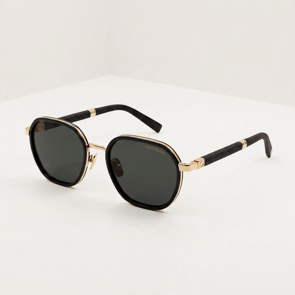 Montblanc black sunglasses with gold trim and textured temples