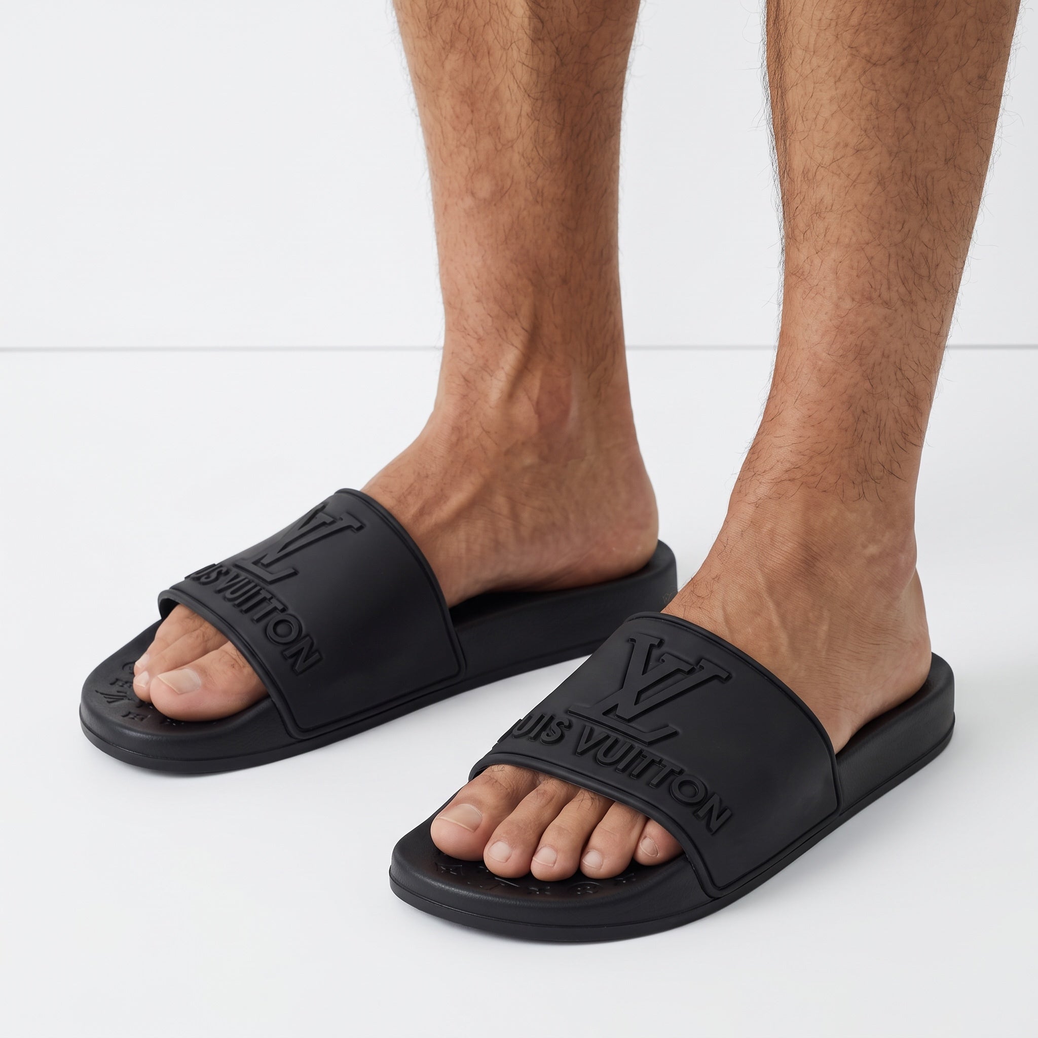black Louis Vuitton embossed logo slides on model feet