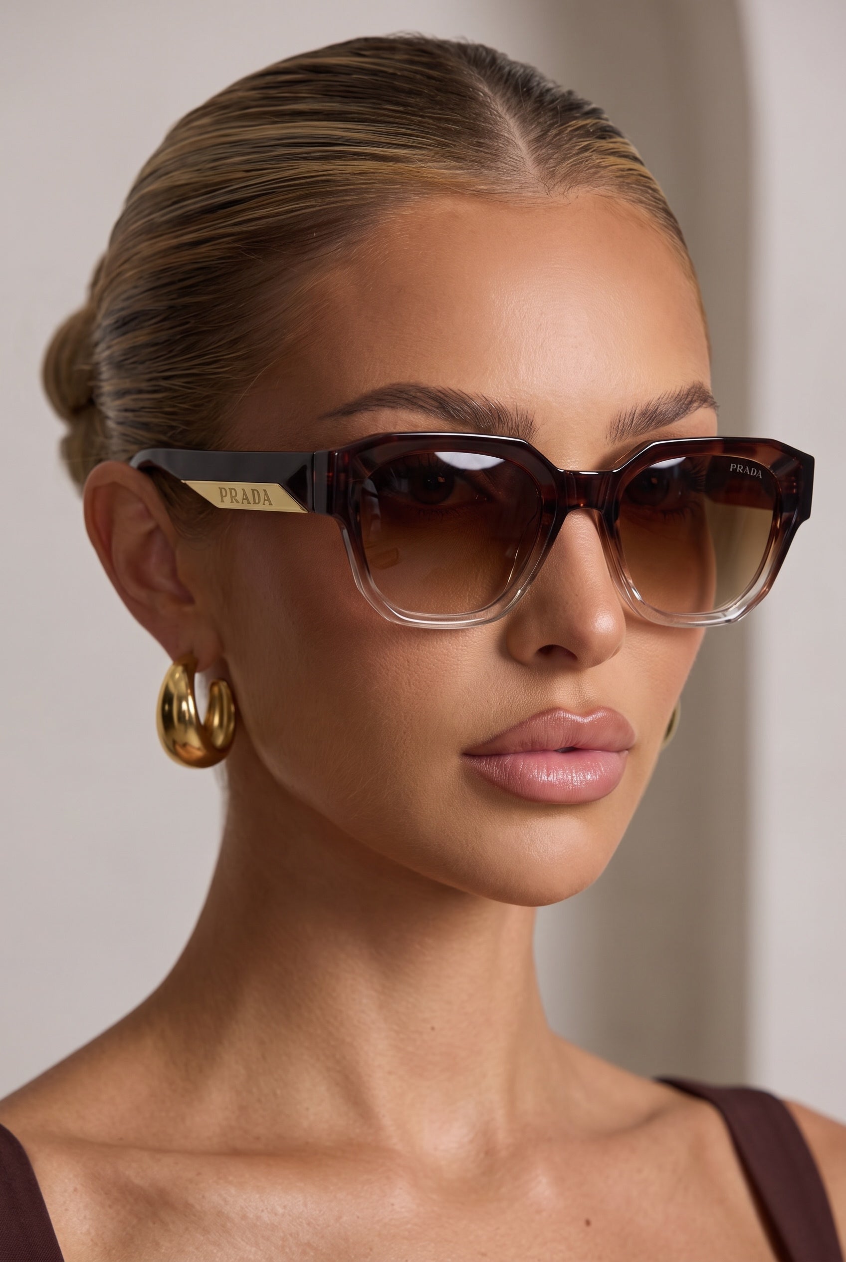 Prada tortoise brown sunglasses with brown gradient lenses and gold Prada plaque on the temple