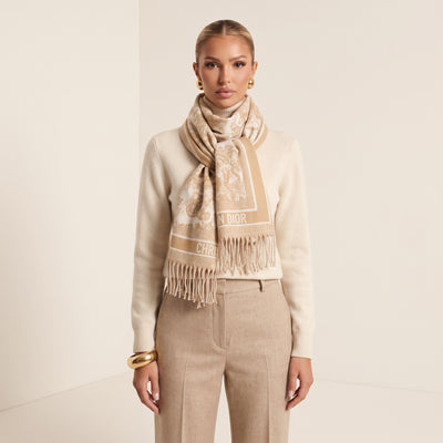 Beige and ivory Dior logo jacquard scarf with fringe wrapped around model