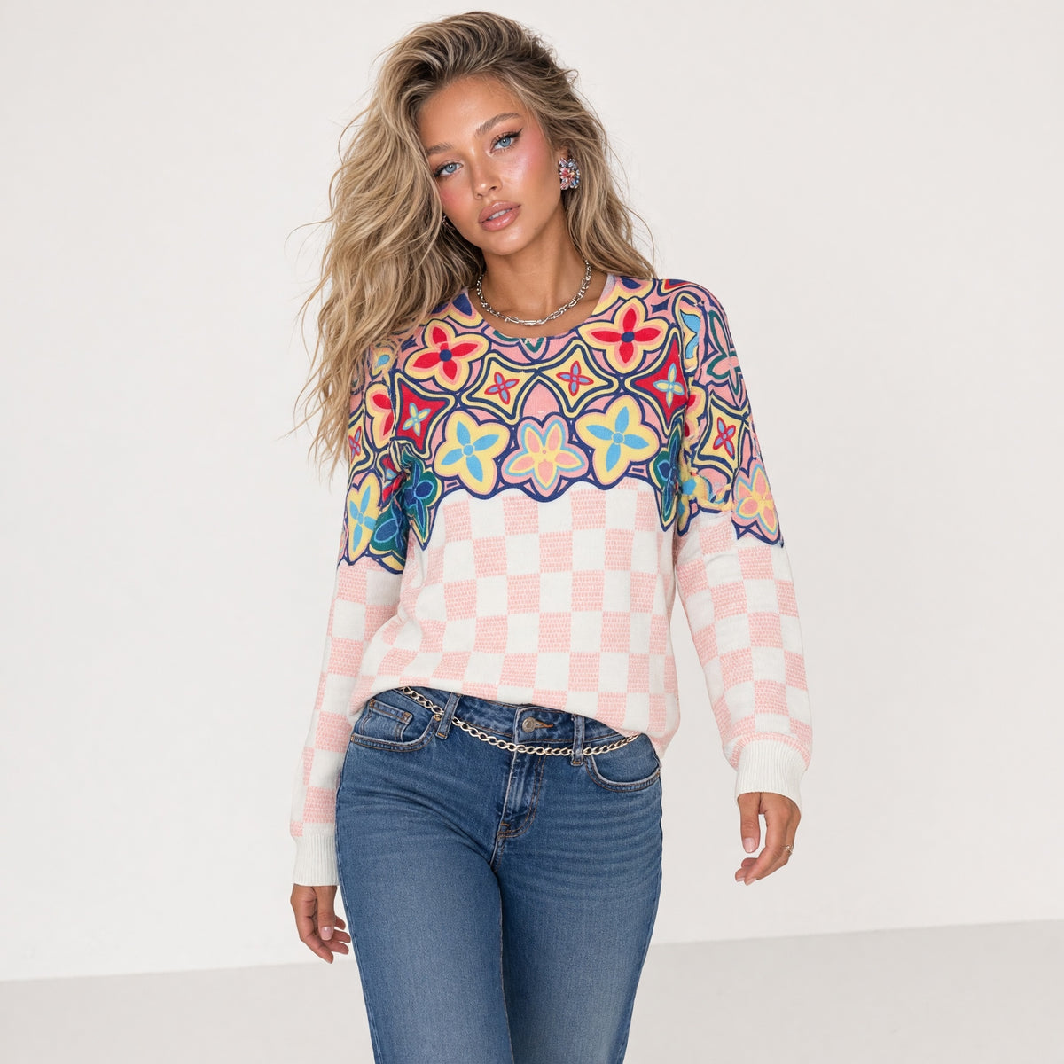 pink checkerboard sweater with multicolor floral yoke and crewneck
