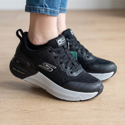 black Skechers trainers with white midsole and knit upper