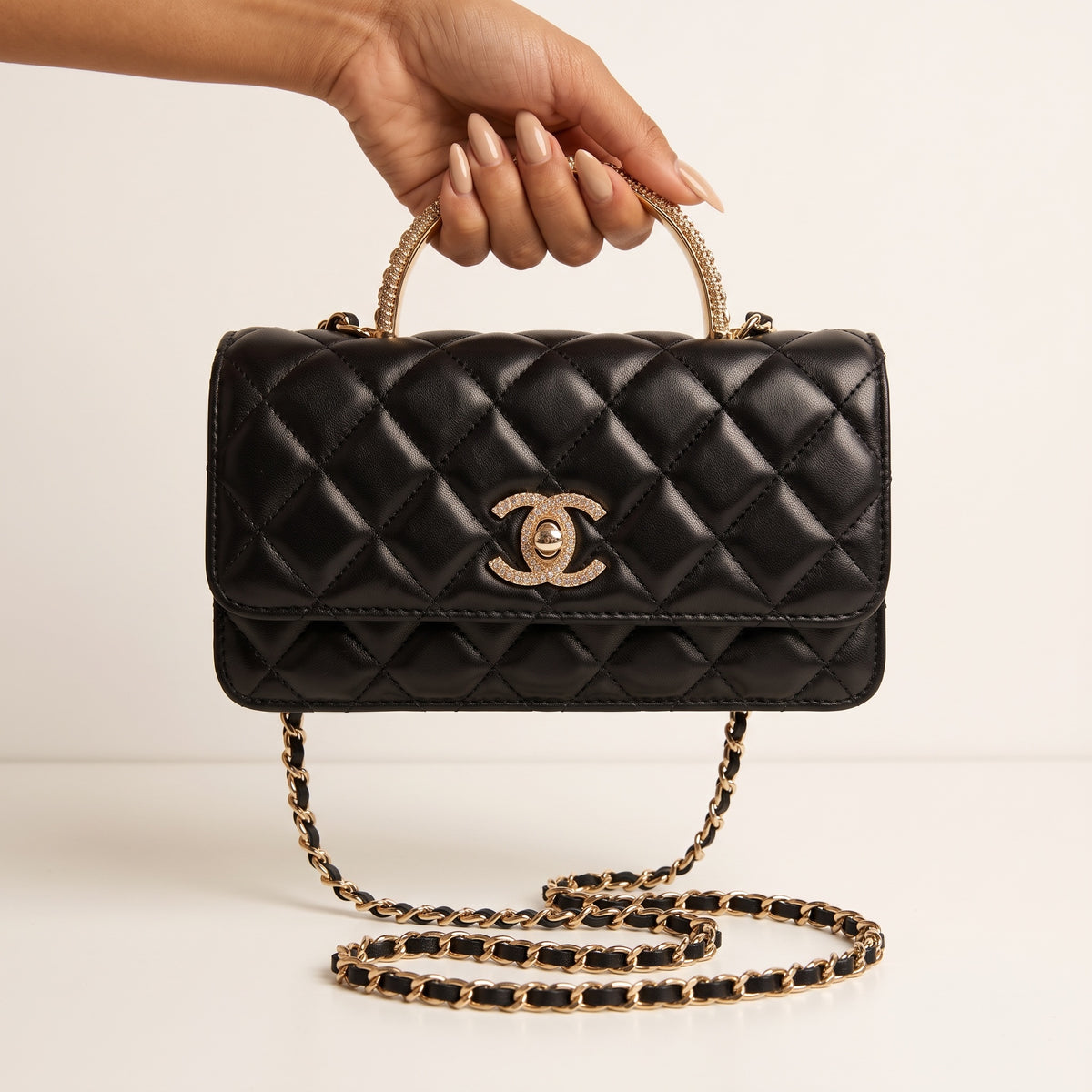 black quilted Chanel flap bag with gold chain strap and crystal top handle