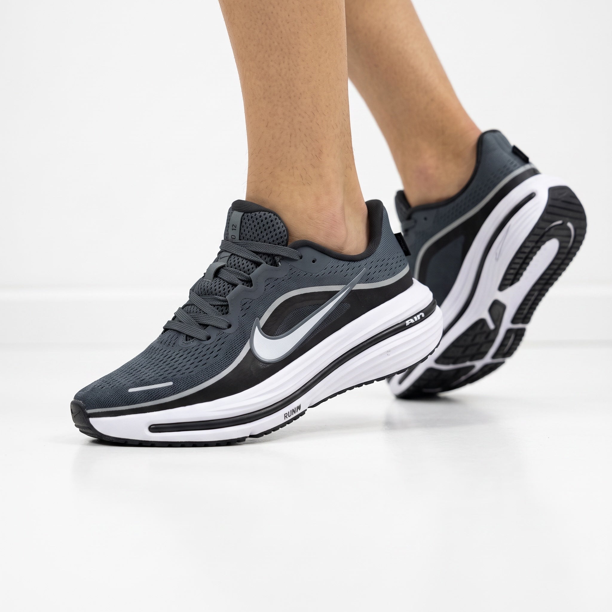 dark grey Nike running trainers with white sole and Swoosh