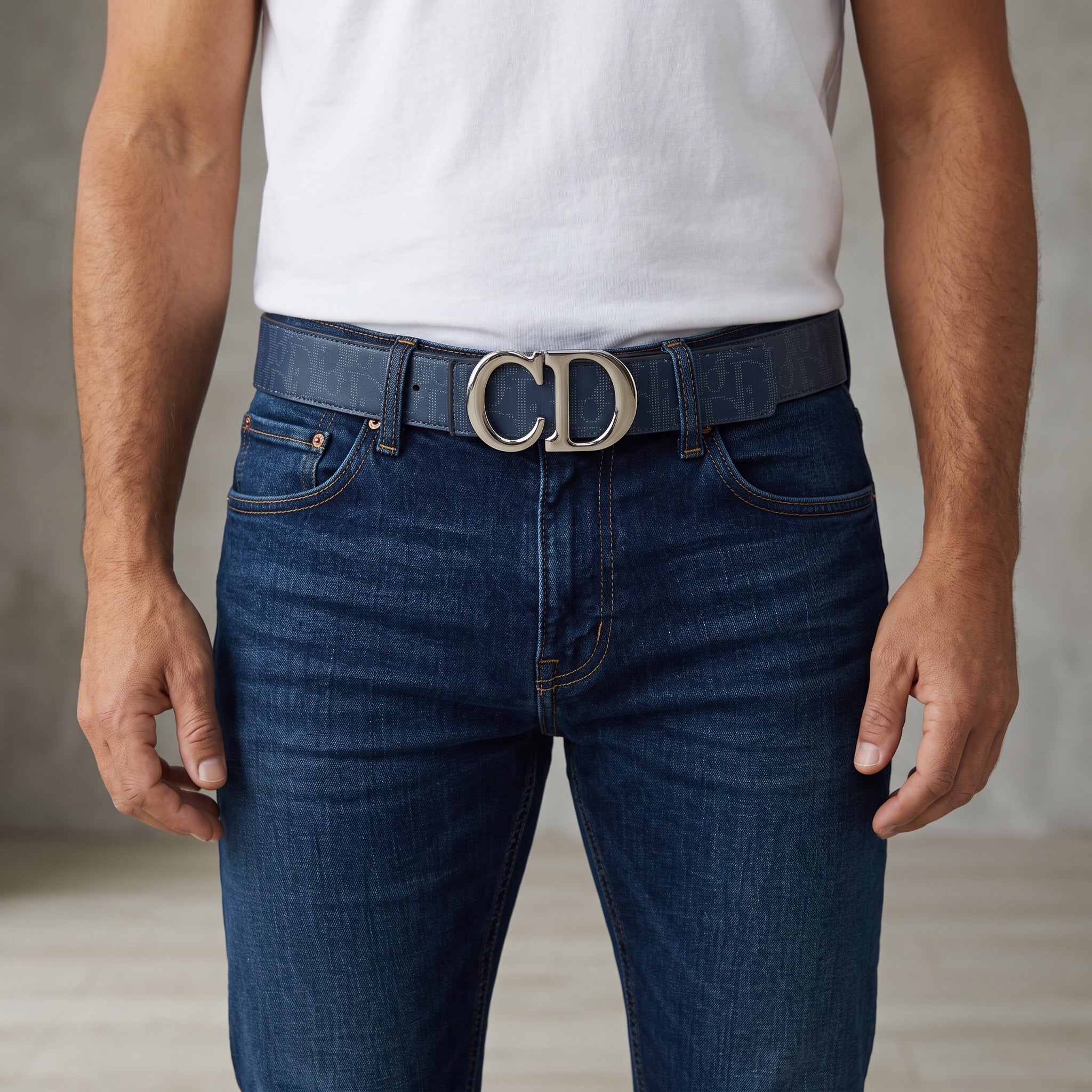 Navy Dior belt with silver CD buckle worn with jeans