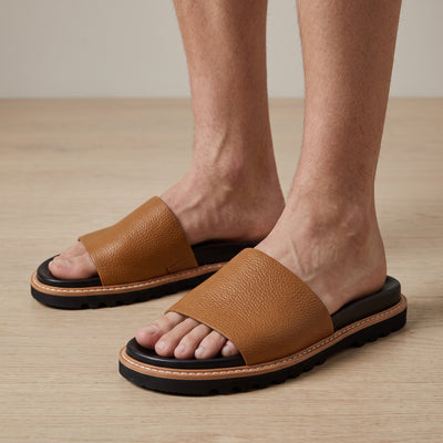 Brunello Cucinelli tan leather men's slide with black cushioned footbed and lug sole