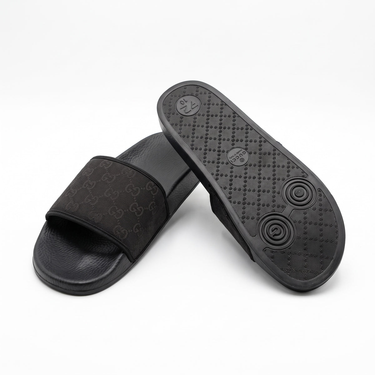 Black Gucci slide with GG monogram strap and rubber outsole