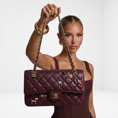 Chanel burgundy quilted flap shoulder bag with gold chain strap and charm pins