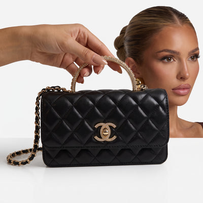 black quilted Chanel flap bag with gold chain strap and crystal top handle