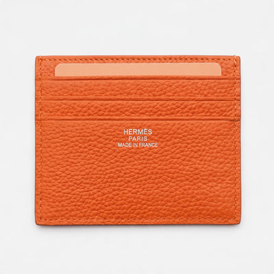 Orange Hermès pebbled leather card holder with embossed H and Hermès Paris stamp