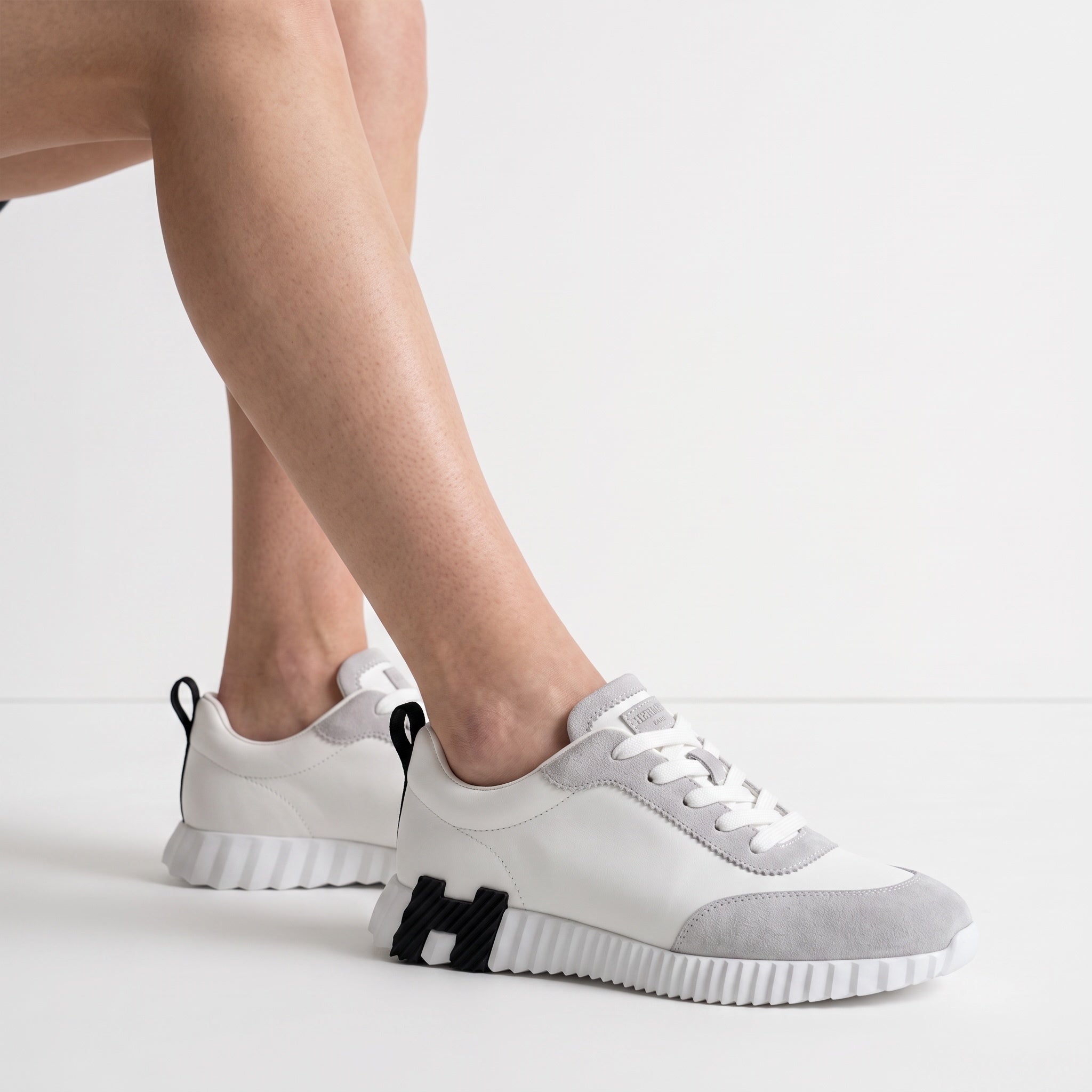 white and grey low-top chunky sneakers with ridged sole and suede-look panels