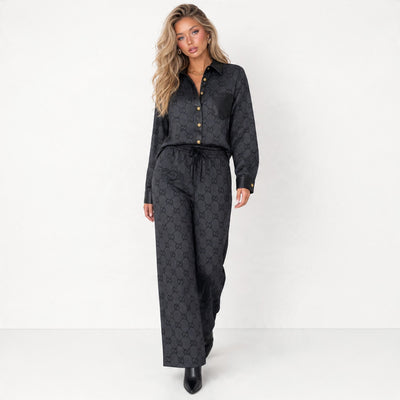 Black Gucci monogram shirt and wide-leg trousers set with contrast trim and gold buttons