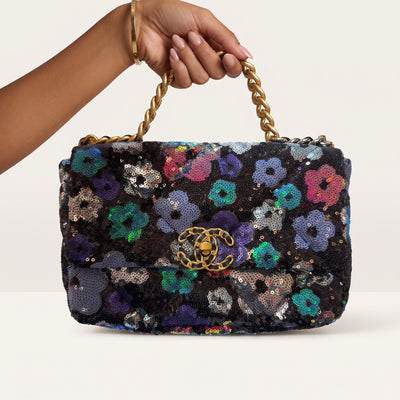 Chanel black sequin floral flap bag with gold CC logo and mixed-metal chain handle
