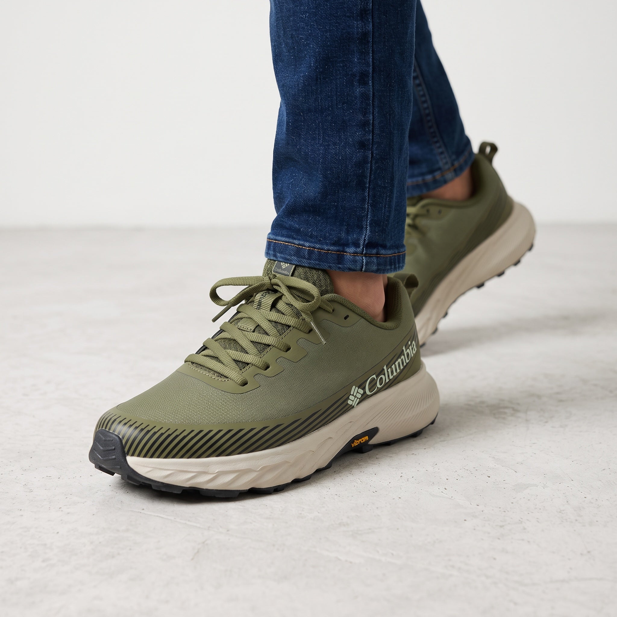 Olive green Columbia sneaker with cream chunky midsole and visible Vibram outsole, side view