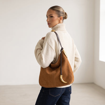 tan hobo bag with gold crescent hardware and single shoulder strap