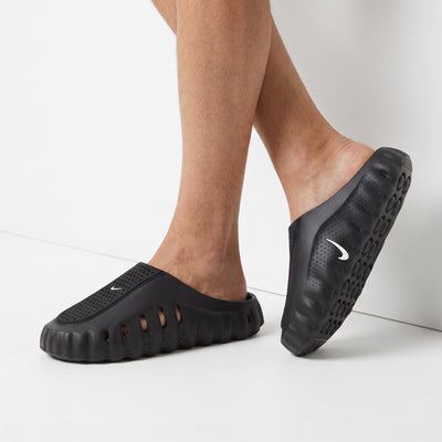 black Nike slip-on clog with perforated upper and white Swoosh