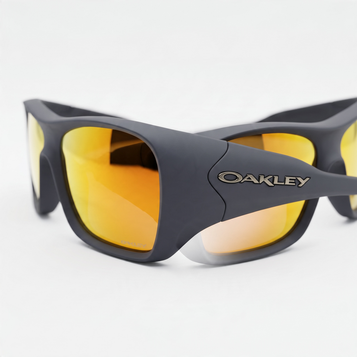 Oakley matte black wraparound sunglasses with orange mirrored lenses